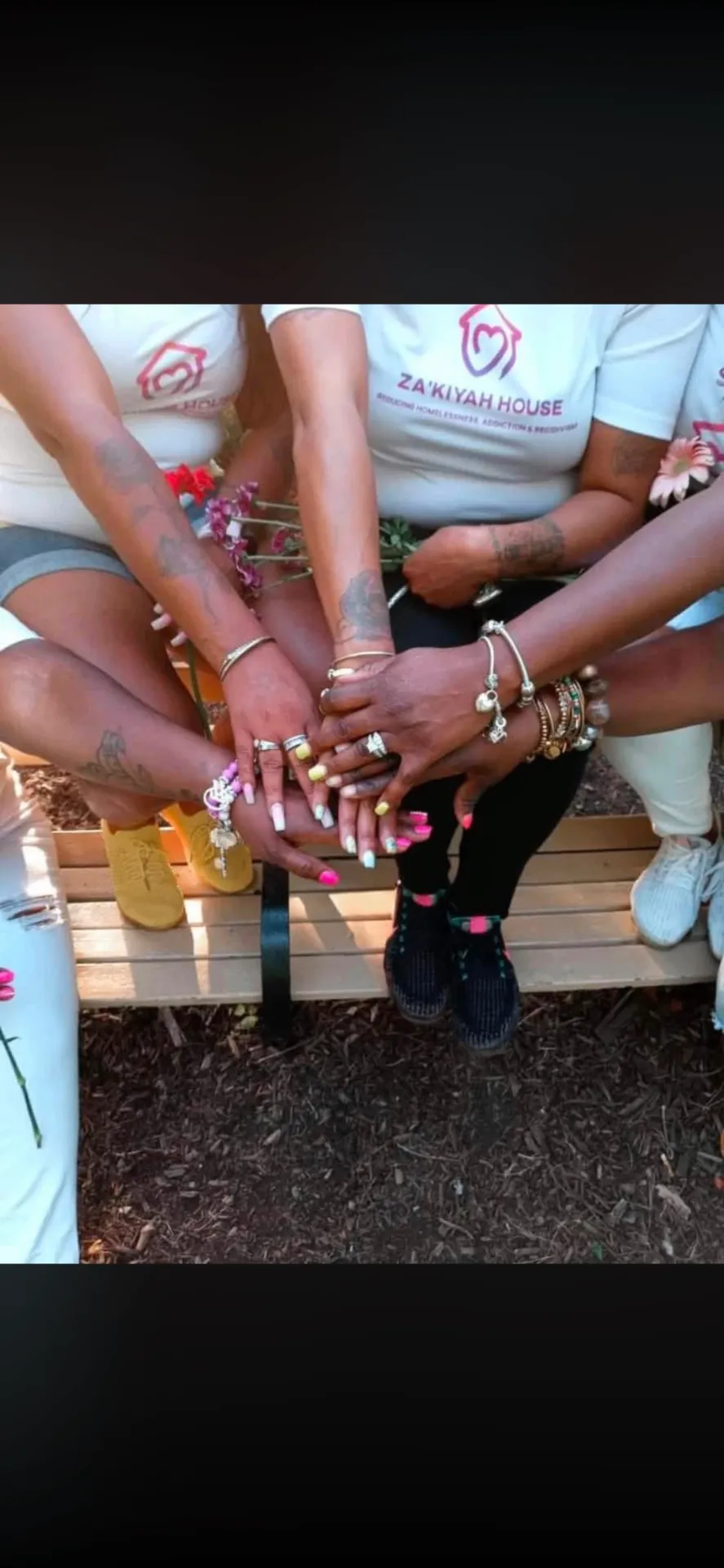 Participants joining hands during a Come Heal With Me gathering