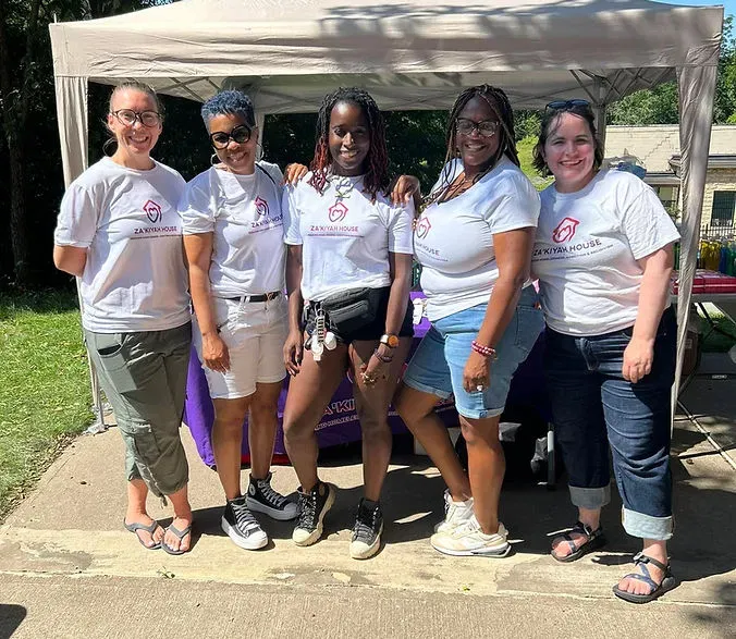 Za'kiyah House team at a community outreach event