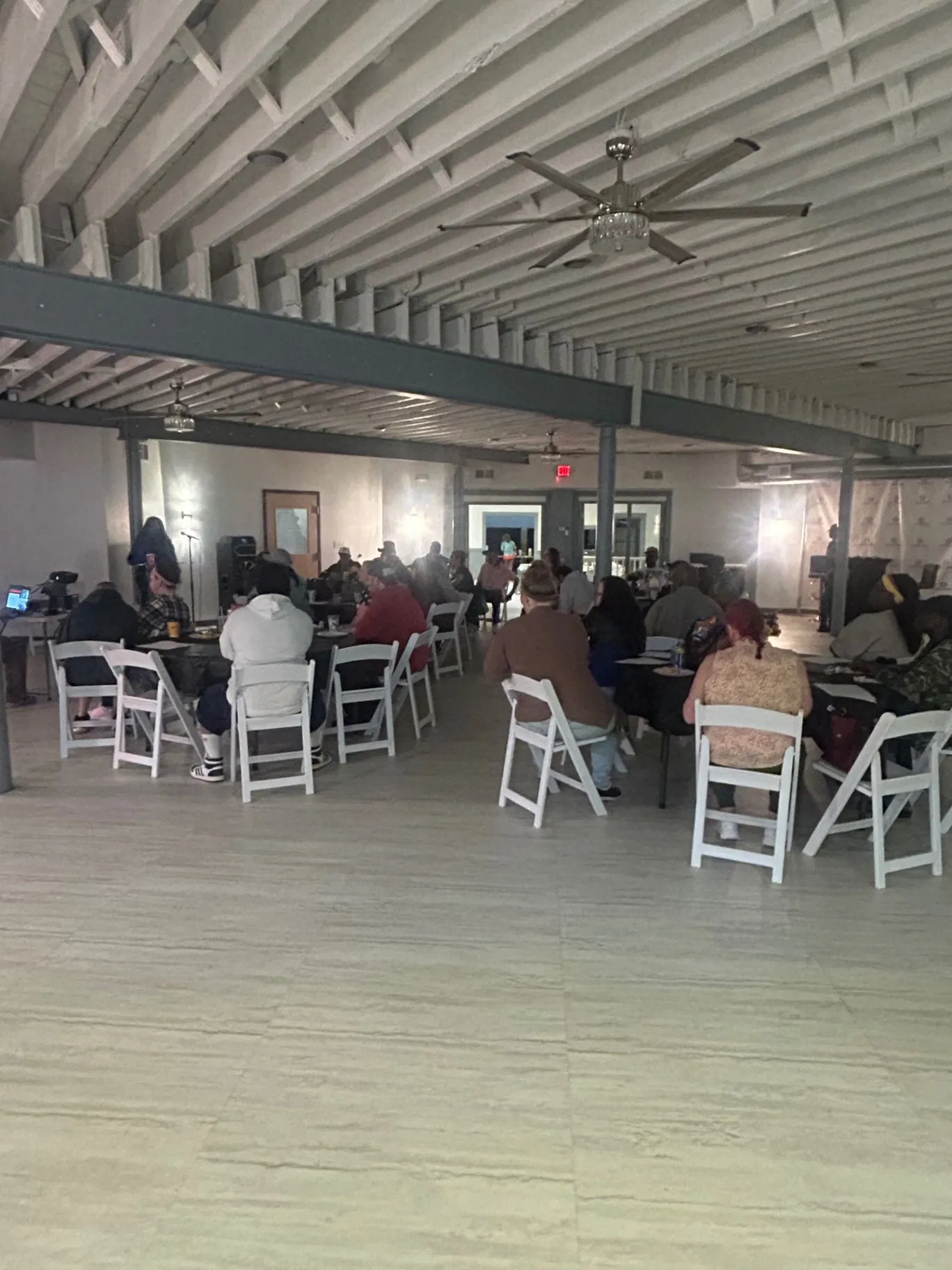 People seated together during a community gathering at The Sanctuary