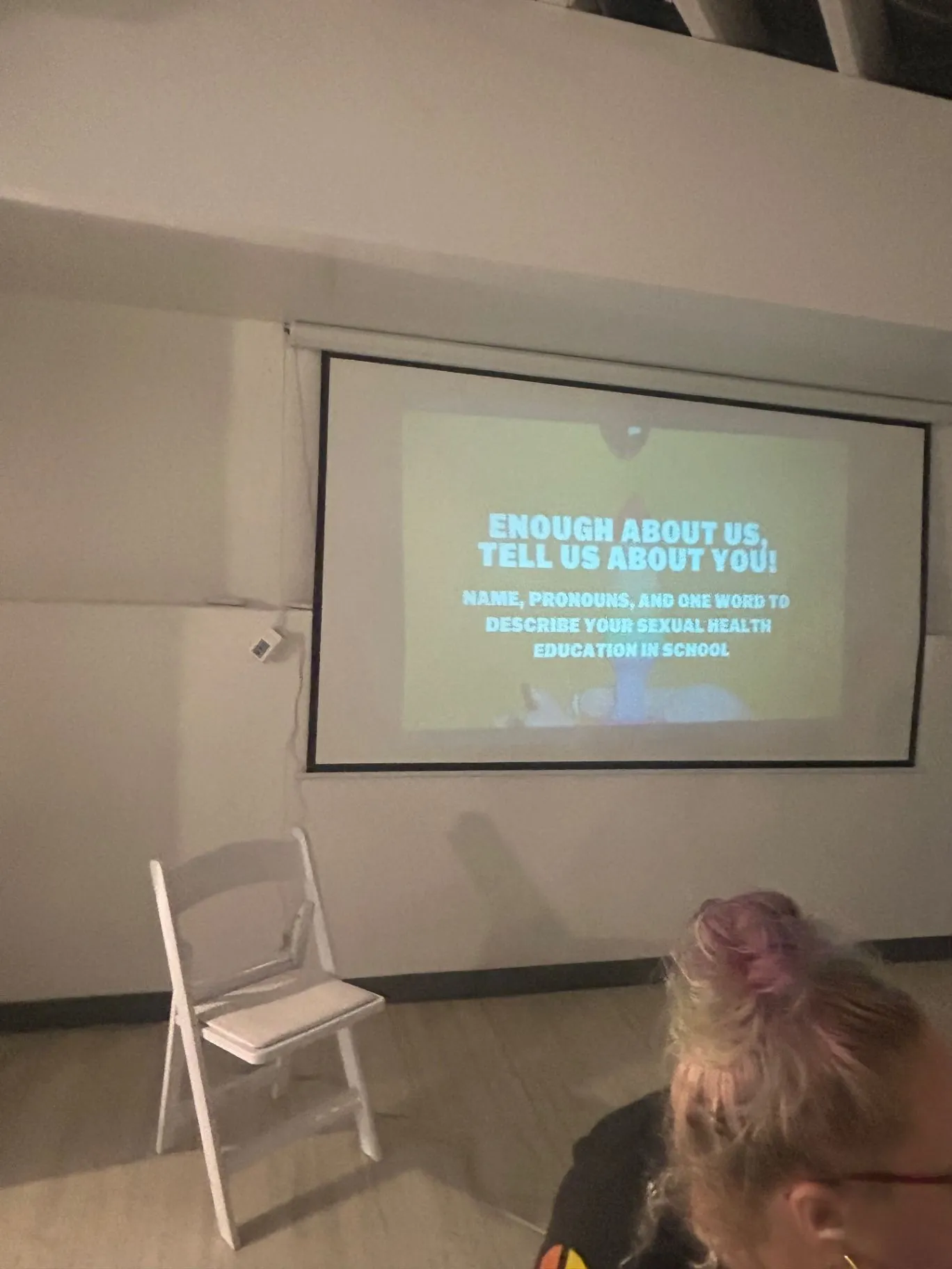 A presentation projected on a screen during a workshop at The Sanctuary